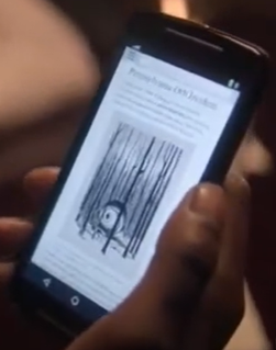 photo du t&eacute;l&eacute;phone de Rufus sur lequel s'affiche un article sur les OVNIS Timeless